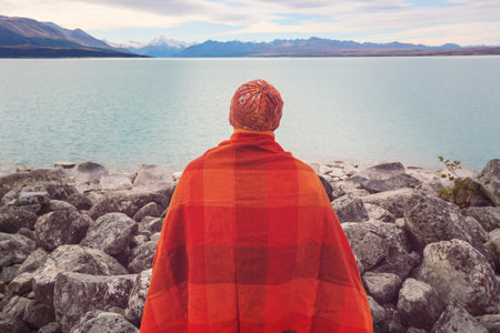 A man is resting at ease by the calm lake. Relaxation vacationの写真素材