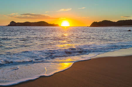 Scenic colorful sunset at the sea coast. Good for wallpaper or background image. Beautiful nature landscapesの写真素材