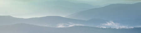 Misty mountain silhouette at sunrise
