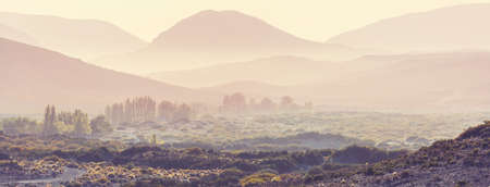 Misty mountain silhouette at sunriseの写真素材