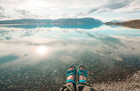 A man is resting at ease by the calm lake. Relaxation vacation