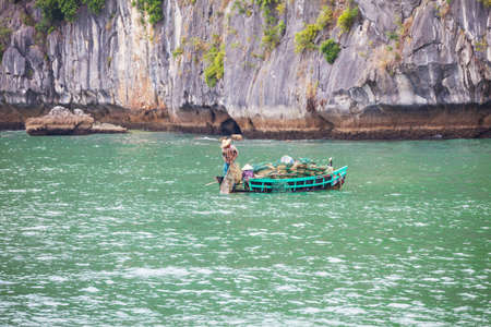 Vietnamese fisherman in Ha Long, Vietnamの写真素材