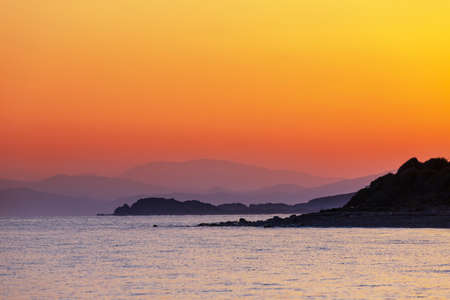 Scenic colorful sunset at the sea coast. Good for wallpaper or background image. Beautiful nature landscapesの写真素材