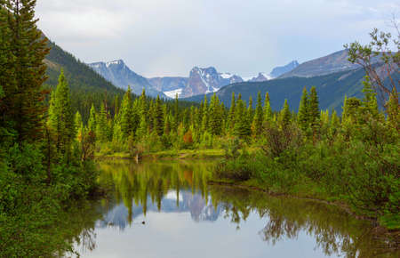 Serene scene by the mountain lake in Canada at sunset