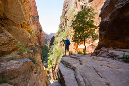 Man in hike in the slot canyon in summer mountains. Utah, USAの写真素材