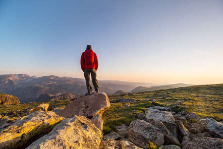 Backpacker in hike in the high mountains