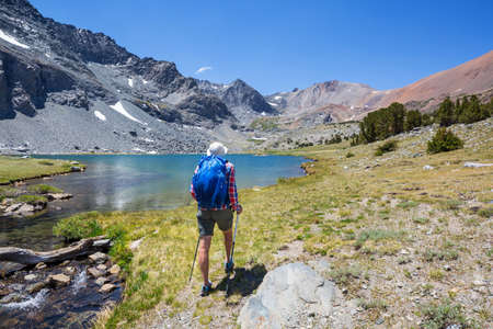 Backpacker in hike in the high mountains