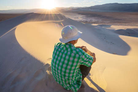 Hiker among sand dunes in the desertの写真素材