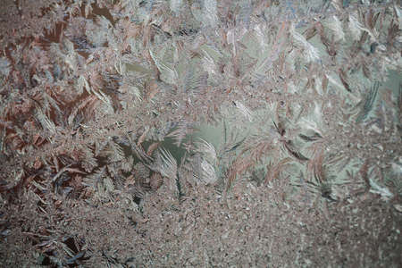 Frozen window. Crystals on a frozen window. Christmas background.