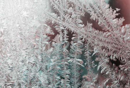 Frozen window. Crystals on a frozen window. Christmas background.