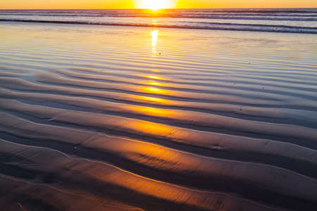 Scenic colorful sunset at the sea coast. Good for wallpaper or background image. Beautiful nature landscapesの写真素材