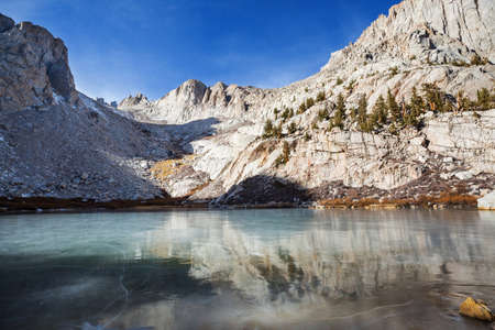 Frozen lake in mountains. Beautiful nature scene in early winter mountains. Sierra Nevada landscapes. USA, California. Travel and winter vacation background.の写真素材