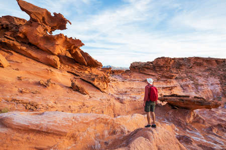 Hiker inside a stone arch in the Nevada desert near Las Vegas, Nevada, USAの写真素材