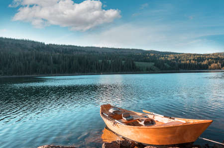 Boat on a beautiful mountains lakeの写真素材