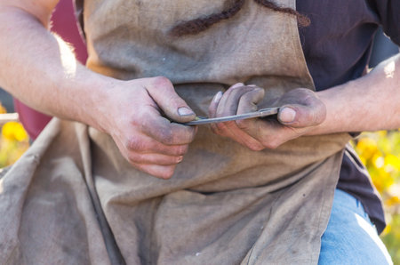 horseshoe in the hand at the blacksmith's workshopの写真素材