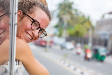 Happy girl riding a local bus in Sri Lankaの写真素材