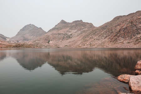 Serenity lake in the mountains in summer season. Beautiful natural landscapes.
