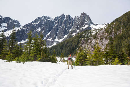 Hiking man in Canadian mountains. Hike is the popular recreation activity in North America. There are a lot of picturesque trails.の写真素材
