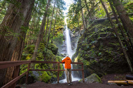 Hiker near  beautiful waterfall in Canadian mountainsの写真素材