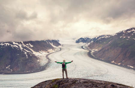 hiker in mountains on beautiful rock backgroundの写真素材