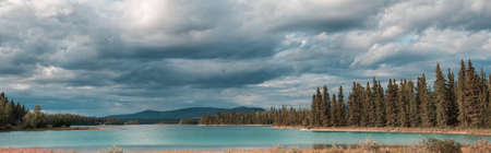 Serene scene by the mountain lake in Canadaの写真素材