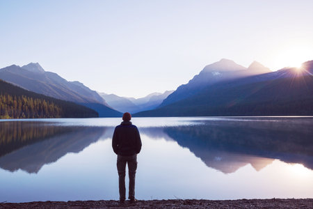 A man is resting at ease by the calm lake. Relaxation vacationの写真素材