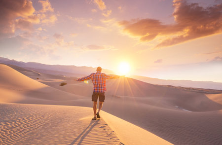 Hiker in sand desert. Sunrise time.の写真素材