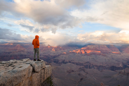 Traveler on cliff mountains over Grand Canyon National Park, Arizona, USA.Inspiring emotion. Travel...
