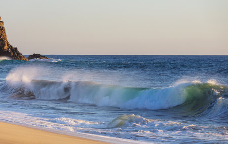 Blue wave on the beach. Dramatic natural background.