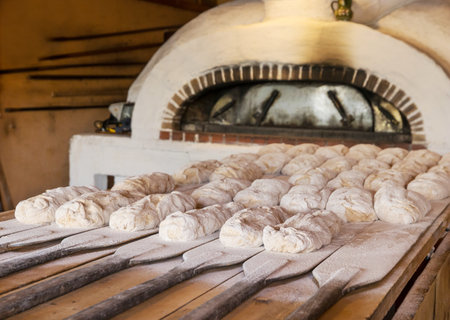 The hand made bread is prepared for oven bakingの写真素材