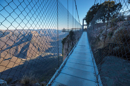 Man on the suspension bridge in Barrancas mountains, Mexicoの写真素材