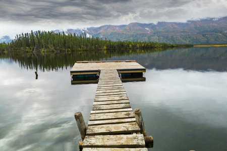 Wooden pier in serenity mountains lake