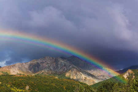 Rainbow above mountains. Beautiful natural landscapes. Picturesque nature.の写真素材