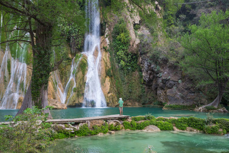 Tourist resting near beautiful waterfall in jungle, Mexicoの写真素材