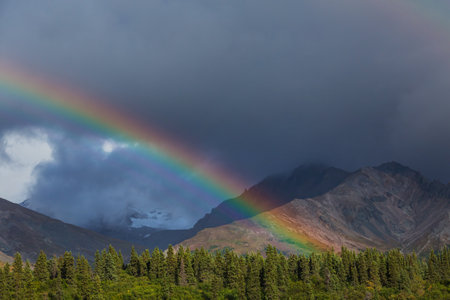 Rainbow above mountains. Beautiful natural landscapes. Picturesque nature.の写真素材