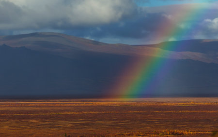 Rainbow above mountains. Beautiful natural landscapes. Picturesque nature.の写真素材