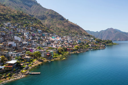 water, travel, mountains, houses, church, village, boats, indigenous, lago atitlan, blue sky, guatemala, lake atitlan, san antonio palopoの写真素材