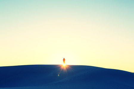Hiker in sand desert. Sunrise time.の写真素材