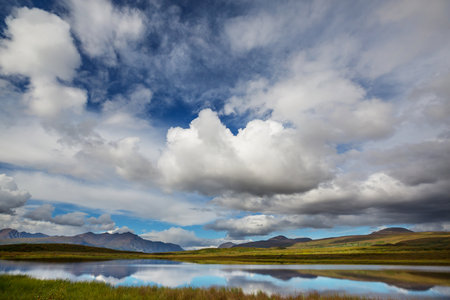 Beautiful blue lake in polar tundra along Dempster highway, Yukon, Canadaの写真素材