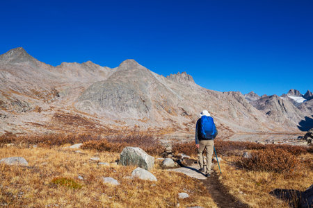 Hike in the autumn mountains. Fall season theme.
