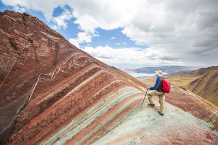 Hiker in Pallay Poncho, alternative Rainbow mountainsの写真素材