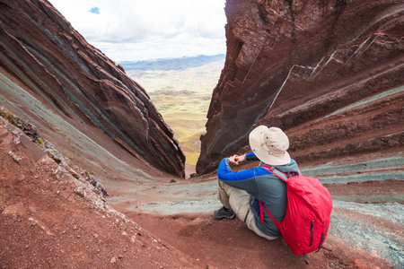 Hiker in Pallay Poncho, alternative Rainbow mountainsの写真素材