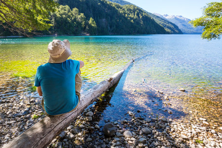A man is resting at ease by the calm lake. Relaxation vacationの写真素材