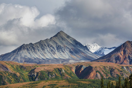 Picturesque Mountains of Alaska in summer. Snow covered massifs, glaciers and rocky peaks. Beautiful...