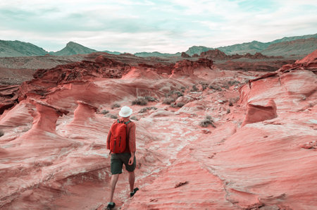 Hiker inside a stone arch in the Nevada desert near Las Vegas, Nevada