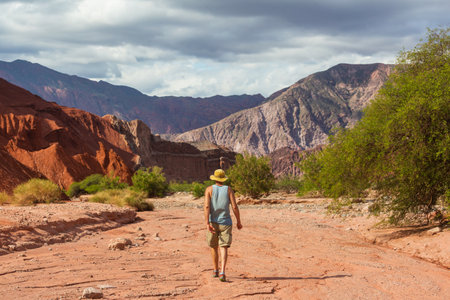 Man walking in the mountains near Cafayate in Northern Argentina, South Americaの写真素材