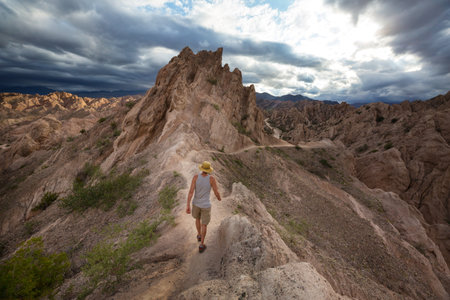 Man walking in the mountains near Cafayate in Northern Argentina, South Americaの写真素材
