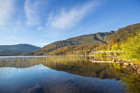 Wooden pier in serenity lake in Patagoniaの写真素材