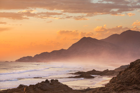 Beautiful rocky beach on the Pacific Ocean in Chile, South Americaの写真素材