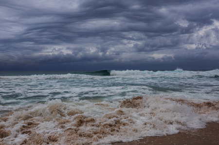 Blue wave on stormy clouds background.. Dramatic natural background.
